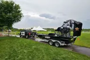 Anoka County Sheriff's pick-up truck pulling an airboat on a trailer cloudy summer day