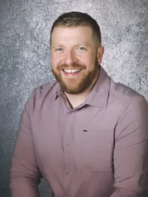 Mayor Ryan Heineman smiling, wearing a dress shirt