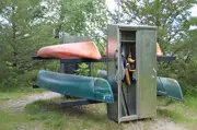 Canoe and Kayak rental station at Sunfish Lake Park, 2 canoes and 2 kayaks in a locked rack