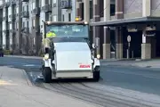 Street sweeper in front of a parking garage
