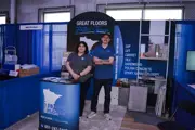 Woman and man posing at 10,000 Floors booth 