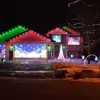 Split-level home with garage on the left, decorated with holiday lights