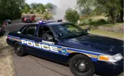 Ramsey police car blocking the road. Fire truck, firefighter and smoke in background.