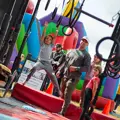 Children swinging from a set of rings on a Ninja course