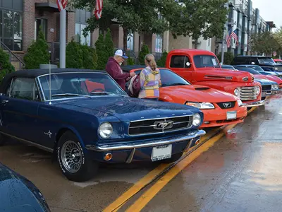 1964-1/2 Mustang Convertible parked at an angle sitting next to another newer 90s Mustang