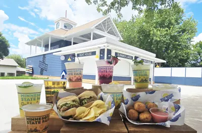Summer Lakes Beverage boat house at Minnesota State Fair with drinks and food in foreground.