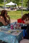 Two women sitting across from each other participating in an art project 