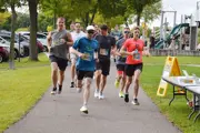 Happy Days 2025 top racers at the start 4 men and 1 woman rounding a corner