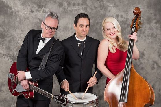 Two men, one with guitar, other with snare drum, one women with a bass