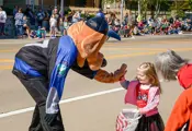 Ramsey police mascot dog high fiving a small girl at the parade