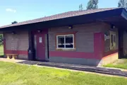 Single story block building with a door in the middle and windows on either side