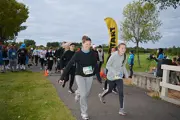 Group of runners with two men pushing strollers