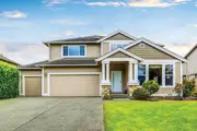 Two-story home with attached garage on left