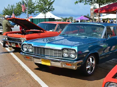 1965 Chevy Impala, wet from a rain shower, sitting next to another Chevy Impala