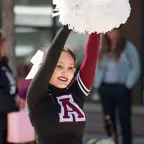 Female Anoka High School Cheerleader with a wide smile walking in the Happy Days parade